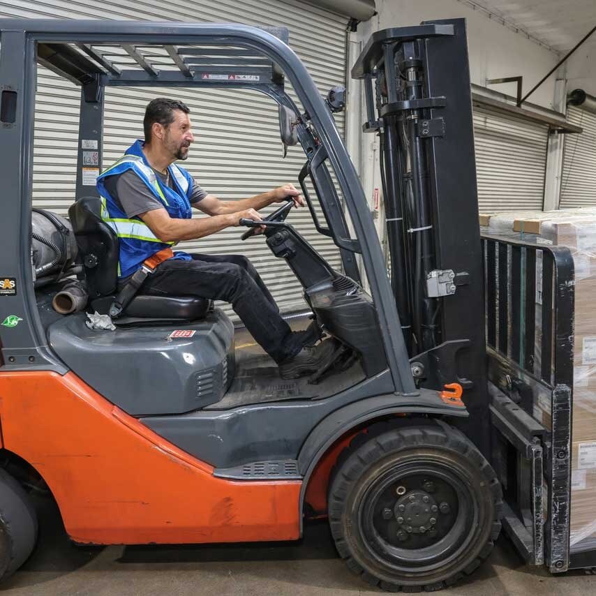 Man Driving Forklift With Full Pallet